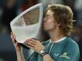 Russia's Andrey Rublev poses affectionately with his trophy after winning the Madrid Open. (EPA PHOTO)