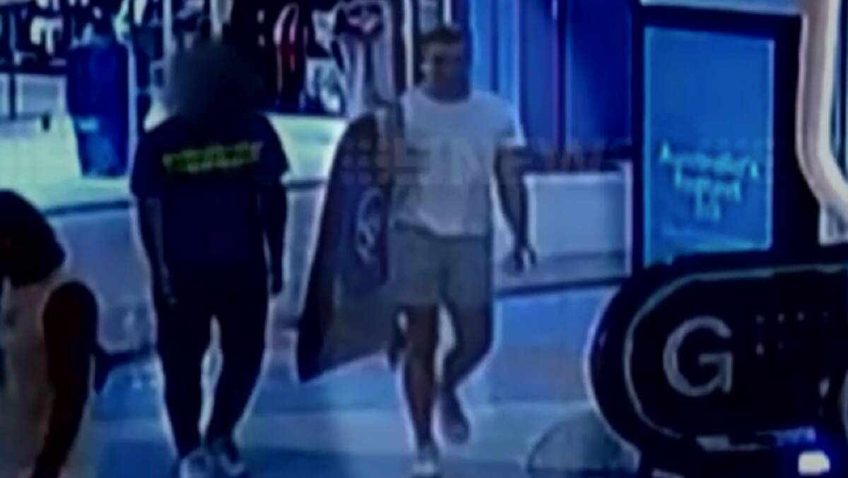 Lamarre-Condon (right) with a friend at the sports store with another surfboard bag two days before the alleged double murder. Picture by 9News