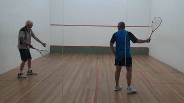 John Taylor in serving action while Stephen Wylie readies for his return. Picture supplied
