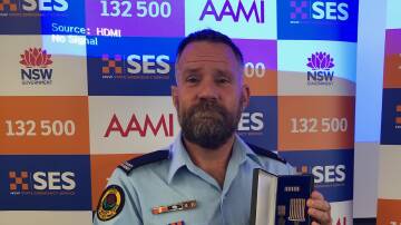 Glen Carr receives his15 year National Medal award from the SES.