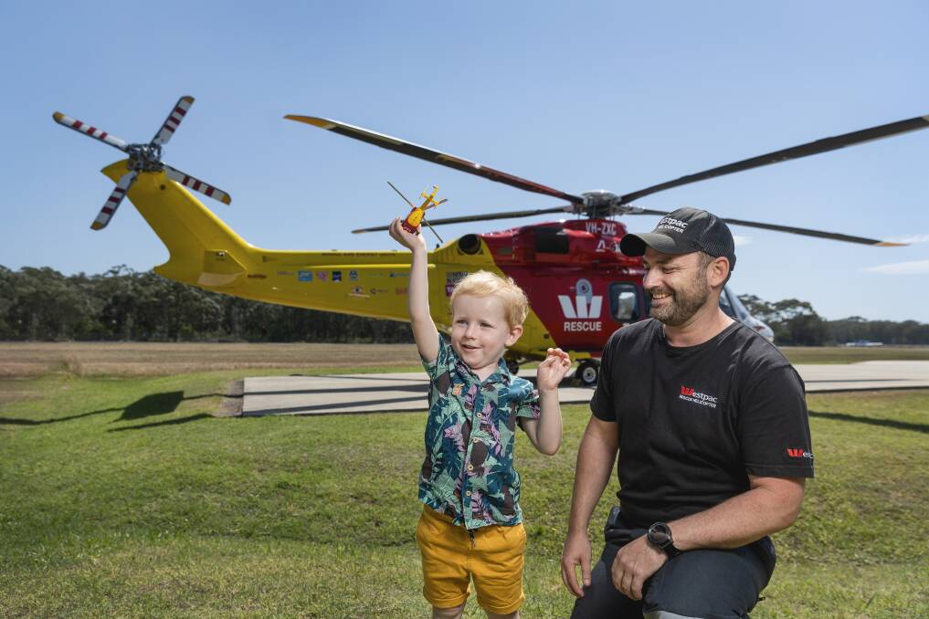 Jamieson Hooper, 4, with Westpac Rescue Helicopter Service training and checking aircrew officer, Kris Larkin. Picture by Marina Neil